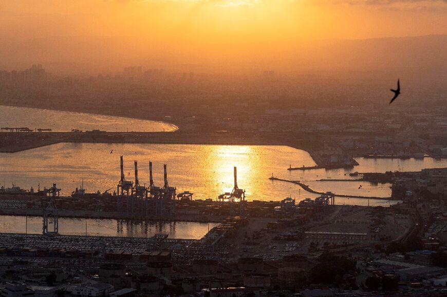 The sun rises over the Israeli port of Haifa