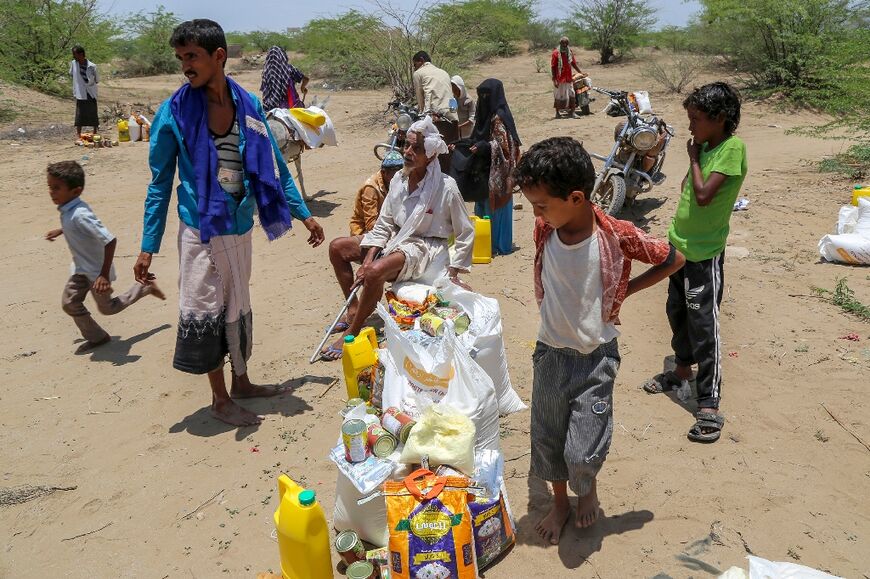 Yemenis displaced by flash floods in the western moutains receive relief supplies in the Hais district of Hodeida province on the Red Sea coast.