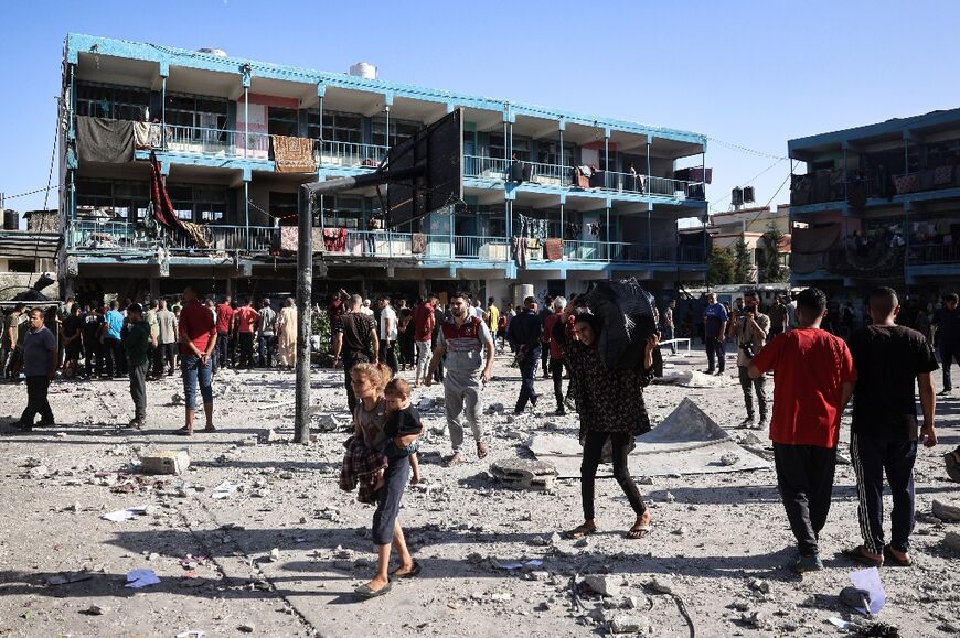 Palestinians in the courtyard of central Gaza's Al-Jawni school after an Israeli air strike