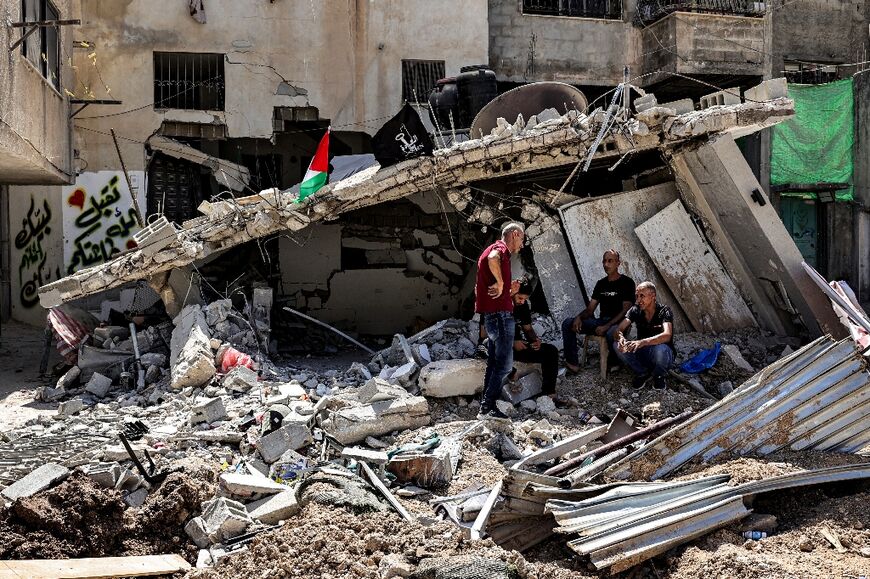 People inspect damage after an Israeli army raid at Nur Shams camp for Palestinian refugees, near Tulkarem in the Israeli- occupied West Bank