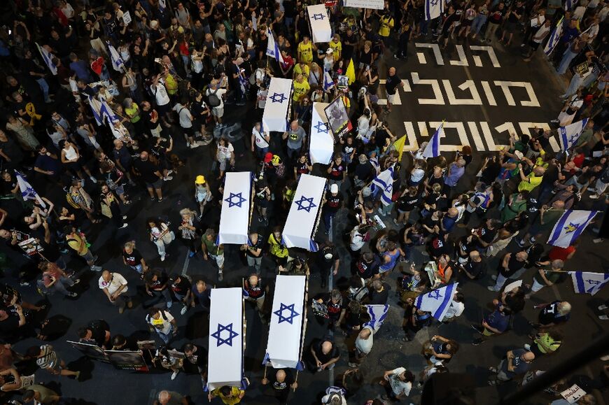 Demonstrators carry symbolic coffins during an anti-government protest calling for action to secure the release of Israeli hostages held in Gaza