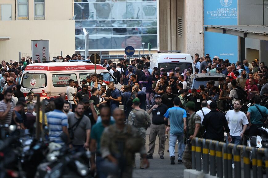 Ambulances are surrounded by people at the American University of Beirut Medical Center, on September 17, 2024