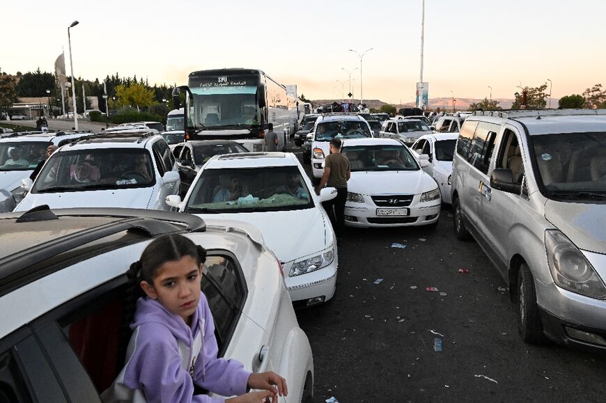 People fleeing from Lebanon arrive on the Syrian side of the border with Lebanon in Jdeidat Yabus in southwestern Syria