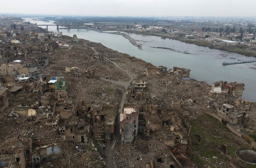 An aerial view in 2022 shows the Tigris river and destroyed buildings in the war-ravaged old part of Mosul heavily damaged by Islamic State group fighters in the 2017 battle for the city