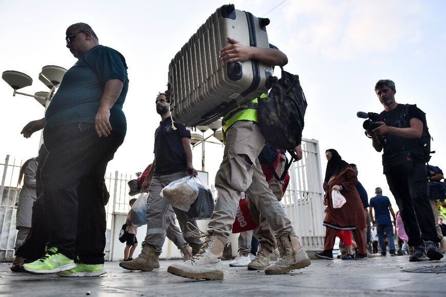 Lebanese who fled southern villages are received at a shelter for displaced people in Beirut