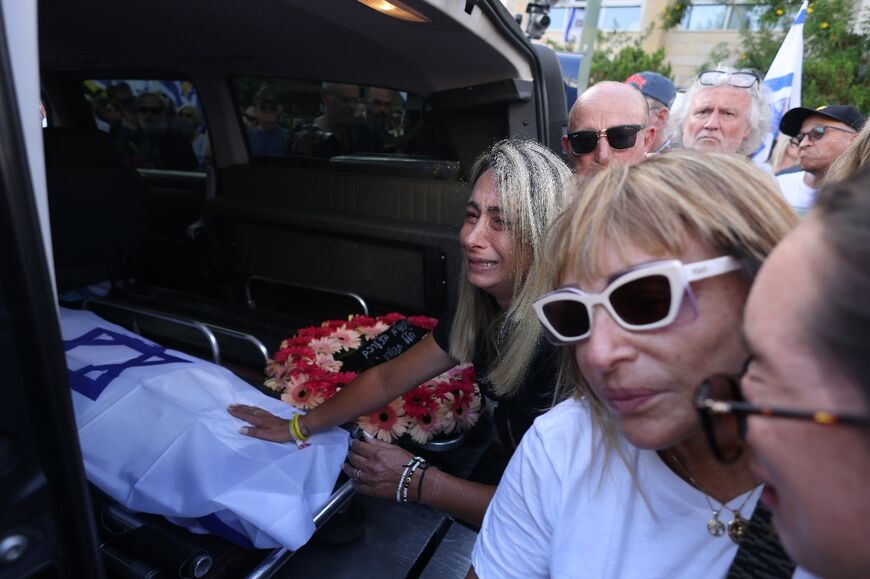 Relatives of Hanan Yablonka, one of the Israeli hostages held in the Gaza Strip since the October 7, 2023 attack by Palestinian Hamas militants, mourn during his funeral in Tel Aviv