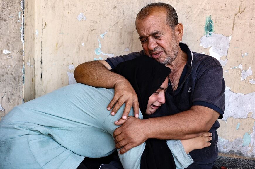 Gazans following an Israeli strike on a school sheltering displaced Palestinians in the northern Gaza Strip