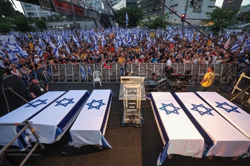 Protesters in Tel Aviv next to symbolic coffins representing the six Israeli hostages whose bodies were recovered