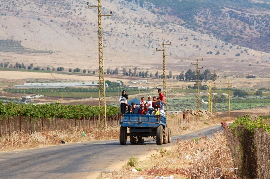 Syrian refugees leave south Lebanon's Wazzani after the Israeli army dropped leaflets calling for them to evacuate