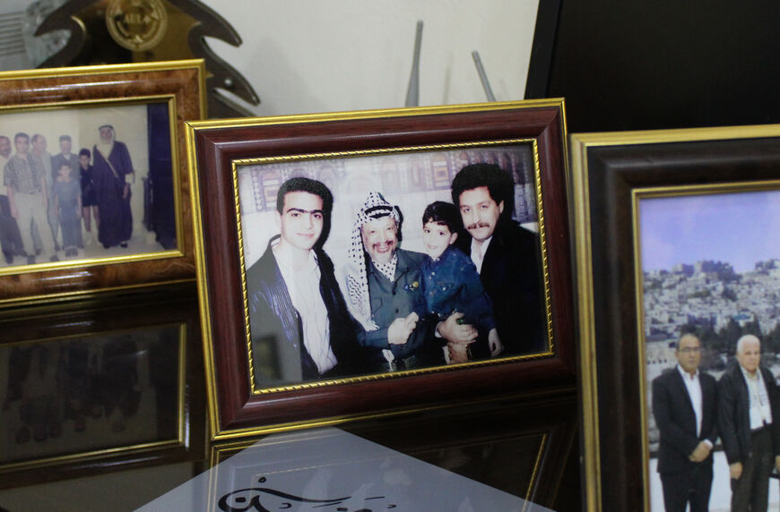 In a photo in Dr. Ainain's office at Al-Hamshari Hospital, a young Ainain (far L) poses next to Yasser Arafat, 1994. 