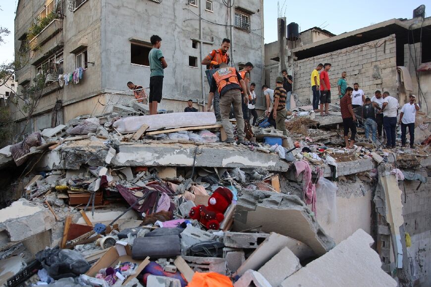 Palestinian medics dig through the rubble of a building as they search for survivors after an Israeli strike on Gaza City