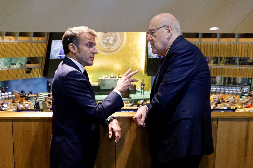 French President Emmanuel Macron (L) speaks with Prime Minister of Lebanon Najib Mikati on the sidelines of the United Nations General Assembly in New York