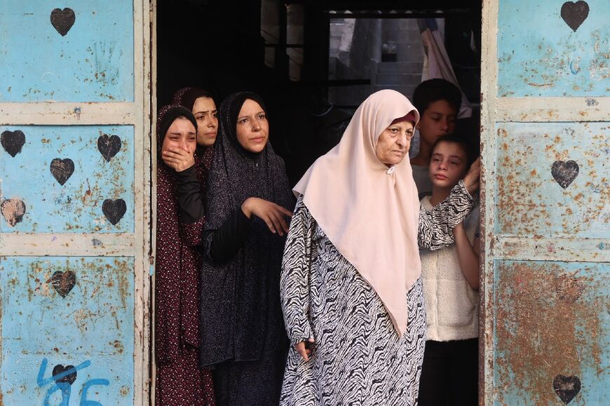 Women mourn a loved one killed in an Israeli strike on the Amr Ibn al Aas school housing displaced Palestinians in Gaza City