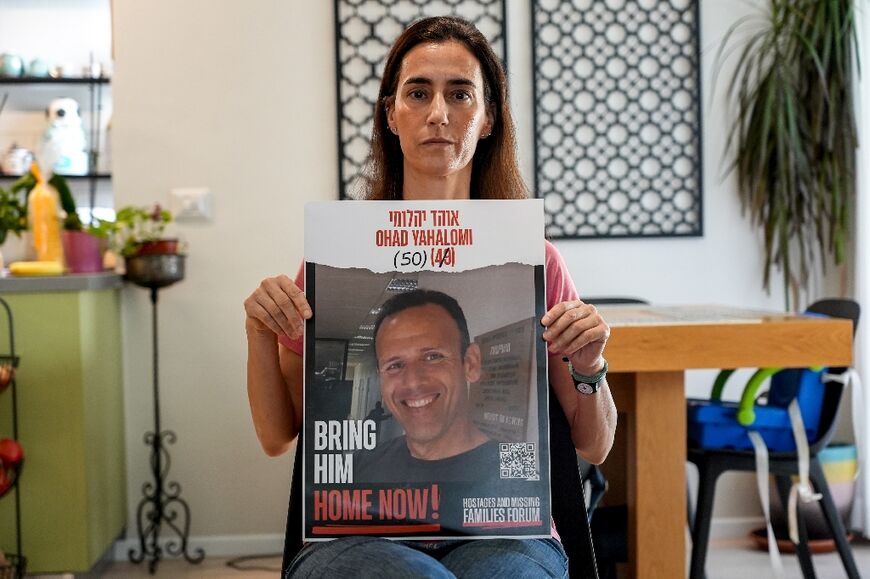 Bat-Sheva Yahalomi, survivor of the attack on Kibbutz Nir Oz, holds a picture of her husband Ohad Yahalomi, who is still remains a hostage