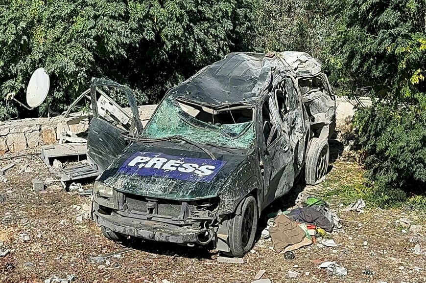 A car marked 'Press' is damaged at the site of a deadly Israeli air strike that targeted an area where a number of journalists were located in the southern Lebanese village of Hasbaya 