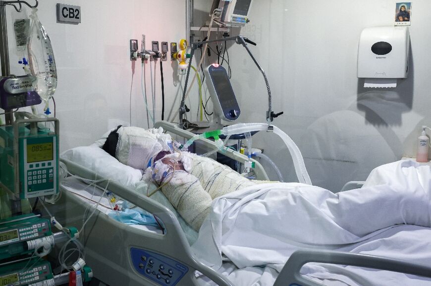 A man burned in an Israeli strike is treated in the ICU at Geitaoui Hospital in Beirut