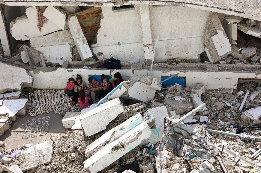 Children in the rubble of northern Gaza, where UN rights chief Volker Turk said the war's "darkest moment" is unfolding