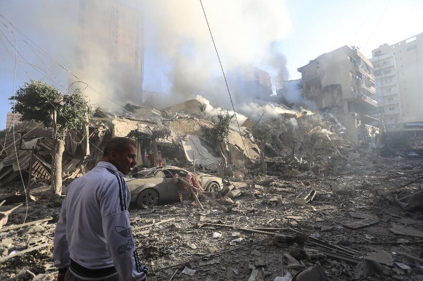 A man walks amid the rubble of a building levelled in an Israeli air strike that targeted the neighbourhood of Moawad in Beirut's southern suburbs 