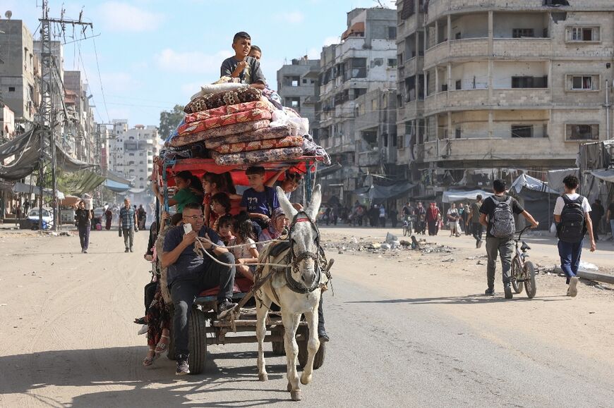 Palestinians flee areas north of Gaza City in the northern Gaza Strip, where the Israeli military is besieging an area around Jabalia