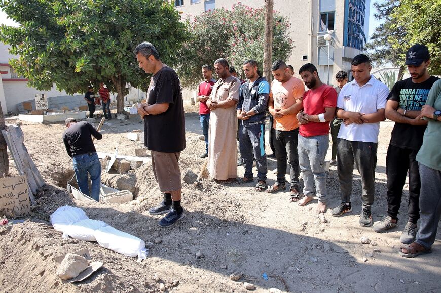 Relatives pray over the shrouded body of ten-year-old Sama al-Debs, who was killed during an Israeli army operation in the Jabalia refugee camp in the central Gaza Strip