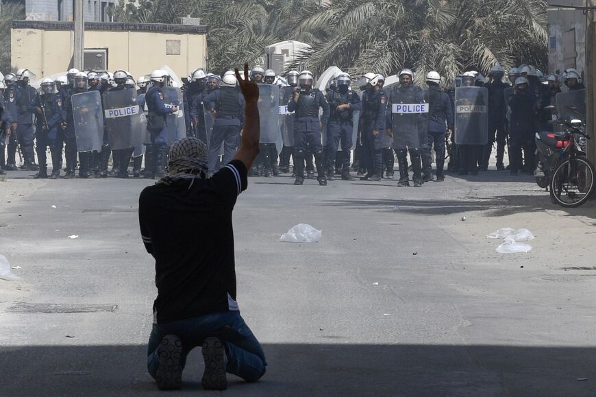 A Bahraini protester flashes the victory sign during clashes with security forces at a pro-Hamas rally in Diraz village