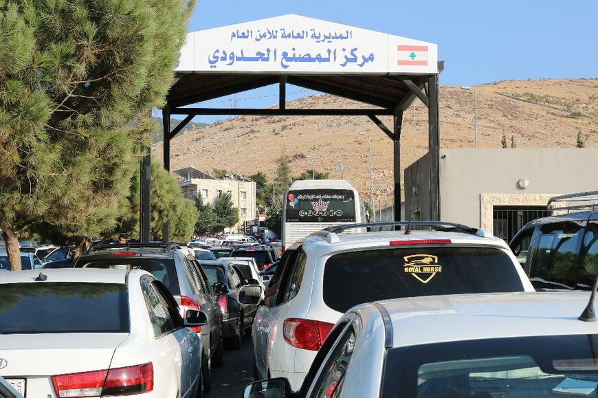 People fleeing Israeli bombings in Lebanon wait to cross the border with Syria through the Masnaa crossing is eastern Lebanon