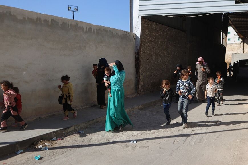 Syrians who were refugees in Lebanon return to their home country after a five-day journey to northern Idlib province where they are received at a temporary resting point in the town of Qah