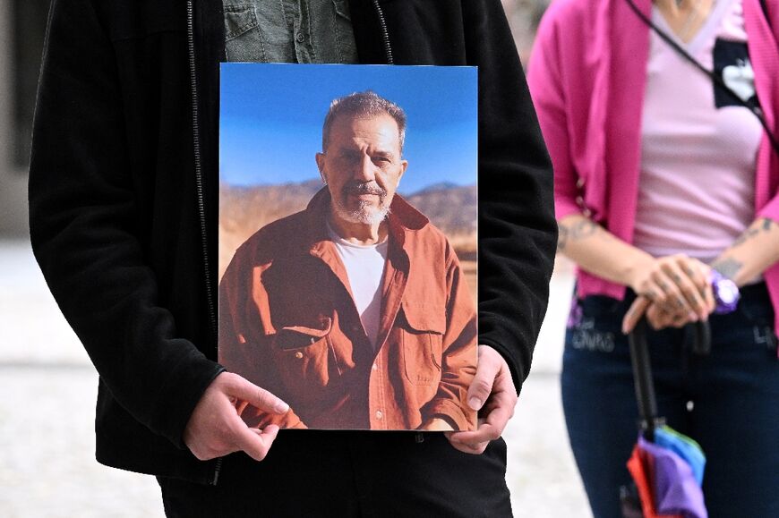 A demonstrator in Germany holds a picture of Iranian-German Jamshid Sharmahd on July 31, 2023