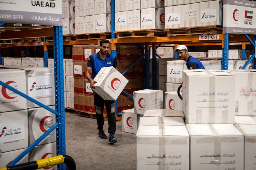 Workers in Dubai pack humanitarian aid destined for Lebanon, where the International Organization for Migration says it has verified 690,000 displaced people, leading to 'huge' needs