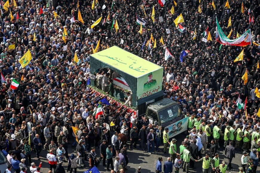 The Arabic slogan, "Surely we will be victorious" is written on a vehicle carrying the coffin of slain General Abbas Nilforoushan, during a funeral procession in Mashhad, Iran