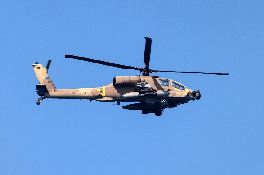 An Israeli Apache AH-64 helicopter flies over the Mediterranean off the city of Netanya toward northern Israel