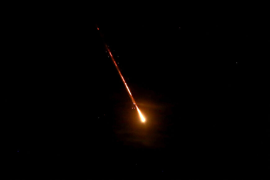 This picture shows a projectile flying above the Jordanian capital Amman towards Israel, on October 1, 2024. Iran's Revolutionary Guards said a missile attack under way against Israel on October 1 was in response to the killing of Hezbollah chief Hassan Nasrallah last week as well as that of the Hamas leader. (Photo by Khalil MAZRAAWI / AFP) (Photo by KHALIL MAZRAAWI/AFP via Getty Images)