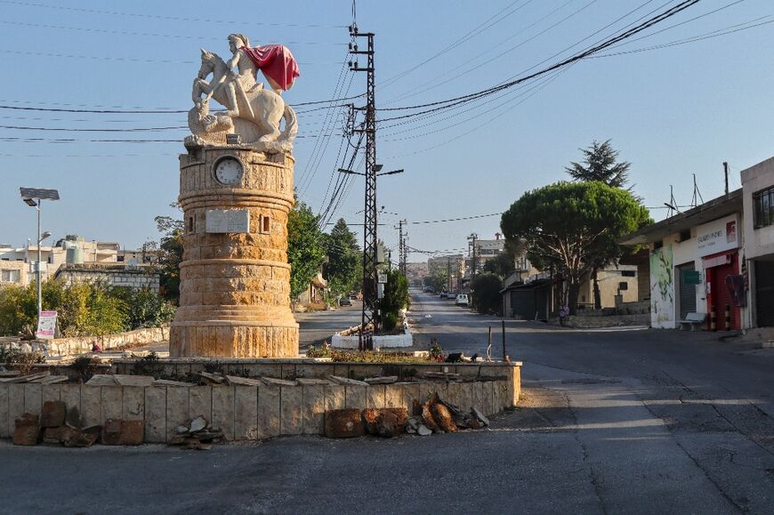 A Lebanese priest said he and others chose to remain in their village because they were "believers bound to our land"