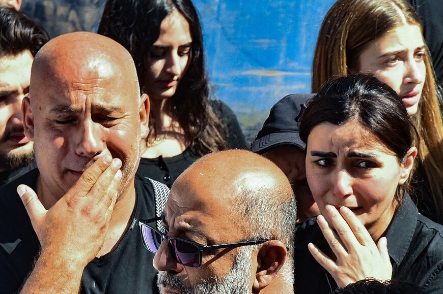 Relatives and colleagues of three journalists killed in an Israeli strike in the southern Lebanese village of Hasbaya mourn as their bodies arrive at a hospital in Beirut