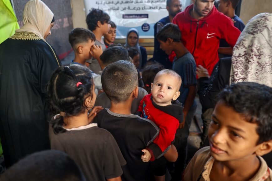 Palestinian children attend a polio vaccination drive in Deir al-Balah in central Gaza