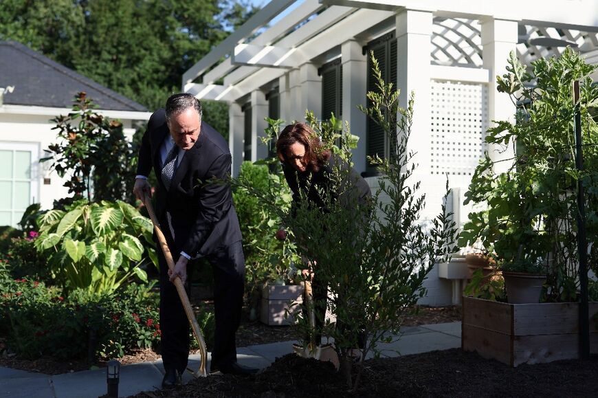 US Vice President Kamla Harris and Second Gentleman Doug Emhoff plant a pomegranate tree on the first anniversary of the Hamas attack on Israel at the Naval Observatory in Washington, DC, on October 7, 2024.