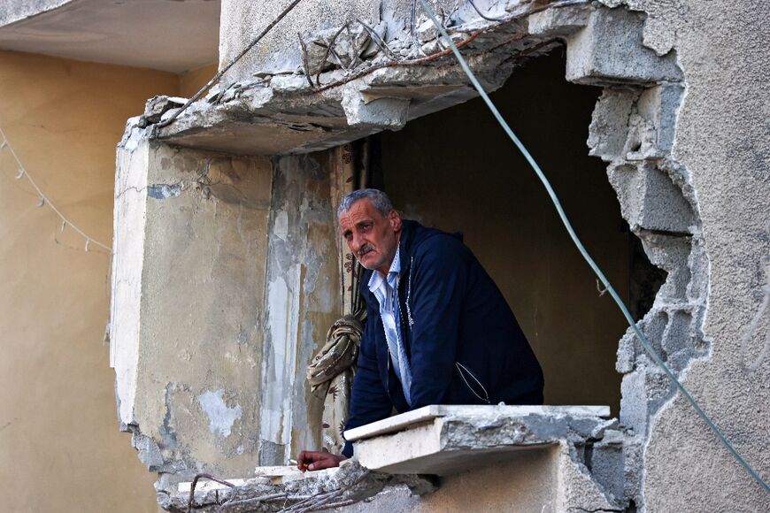 A man looks out of his damaged apartment following an Israeli raid on Nur Shams camp for Palestinian refugees, near Tulkarem in the Israeli-occupied West Bank 