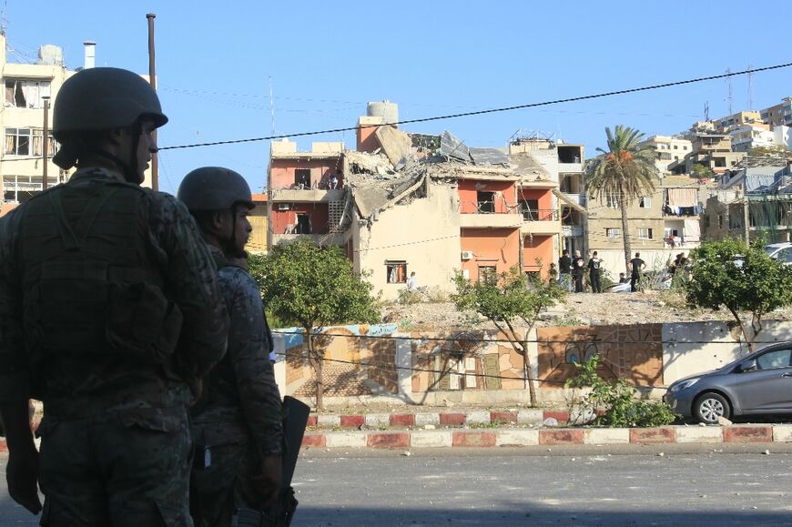 Lebanese army soldiers cordon off the site of an Israeli strike in Sidon