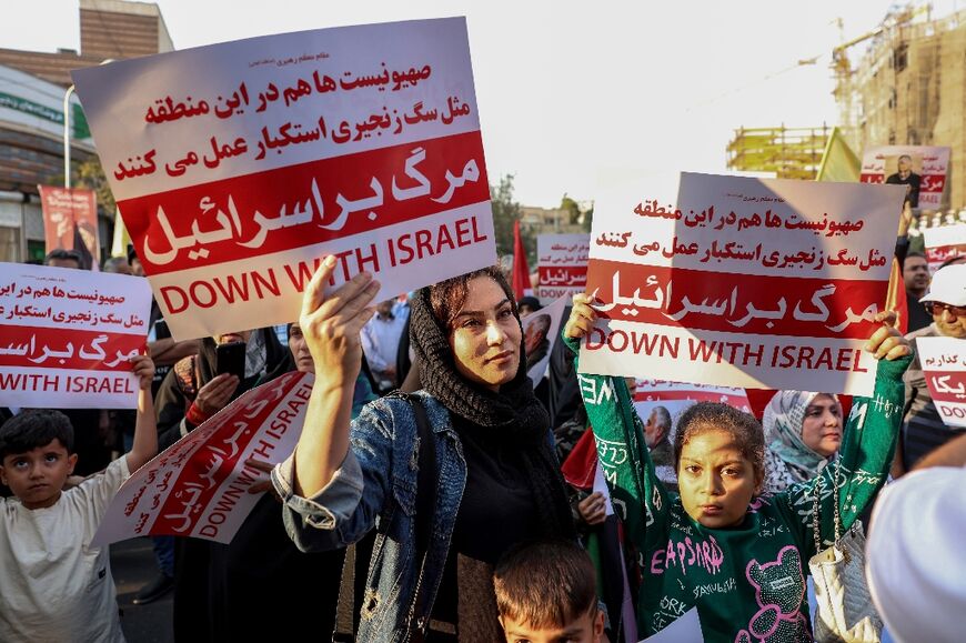 Iranians hold slogans during an anti-Israel rally in Tehran