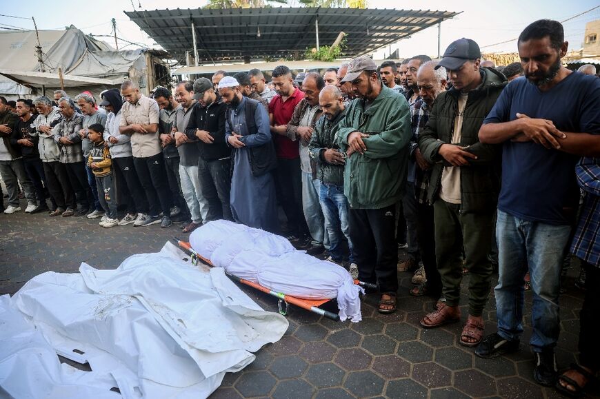 Mourners pray over the bodies of victims of an Israeli strike, during a funeral at Al-Aqsa Martyrs Hospital in Deir el-Balah