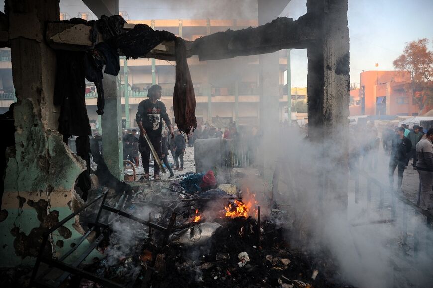 A fire burns amid the debris following an Israeli strike that hit a UN-run school where people had taken refuge, in the Nusseirat refugee camp in the central Gaza Strip