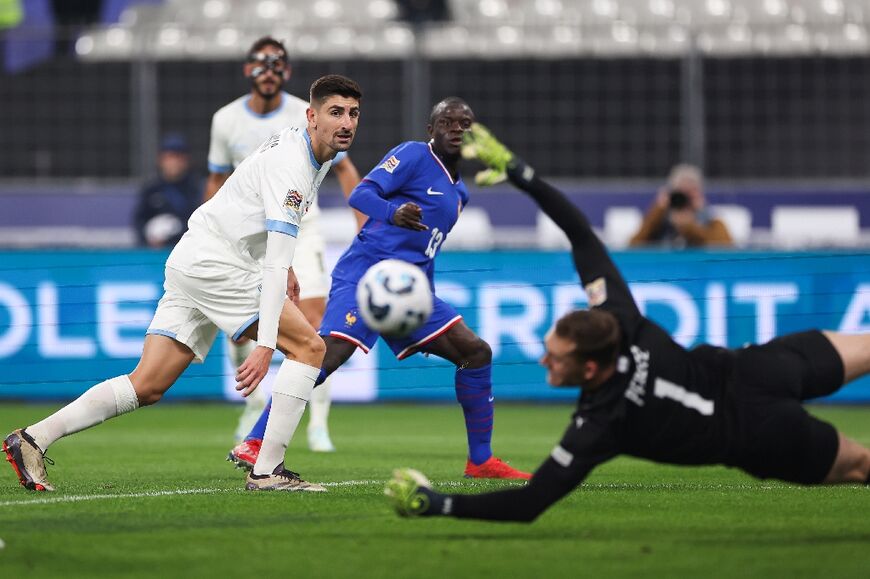 France midfielder N'Golo Kante narrowly misses with a shot as the Israeli defenders look on