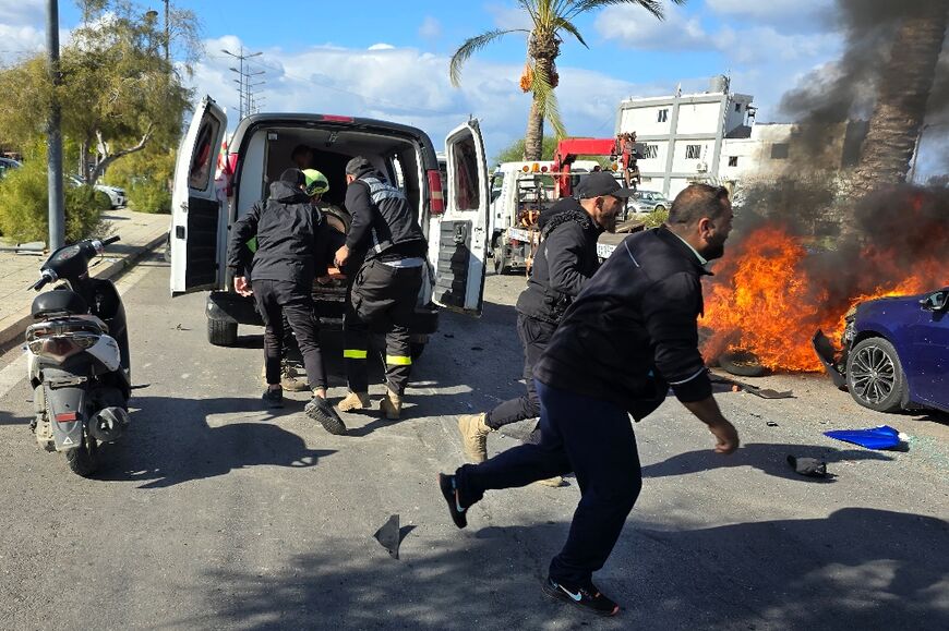 Emergency responders arrive at the site of an air strike in the southern Lebanese city of Tyre on Monday