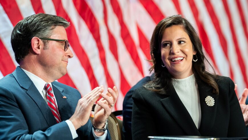 US Representative Elise Stefanik (R-NY) is acknowledged by President-elect Donald Trump alongside US Speaker of the House Mike Johnson (L) during a House Republicans Conference meeting at the Hyatt Regency on Capitol Hill on November 13, 2024 in Washington.