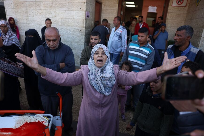 A Palestinian woman reacts as victims of an Israeli strike are transported to the al-Aqsa Martyrs Hospital in Deir el-Balah in the central Gaza Strip on November 17, 2024