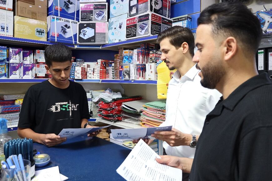 Young men in Misrata discuss leaflets handed out by election campaigners