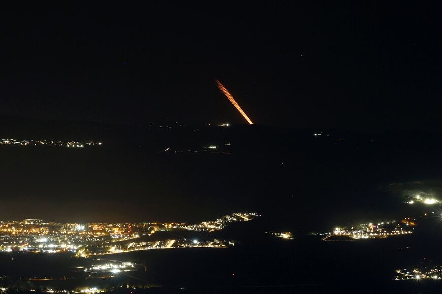 Seen from northern Israel, a barrage of rockets is fired from a position in south Lebanon