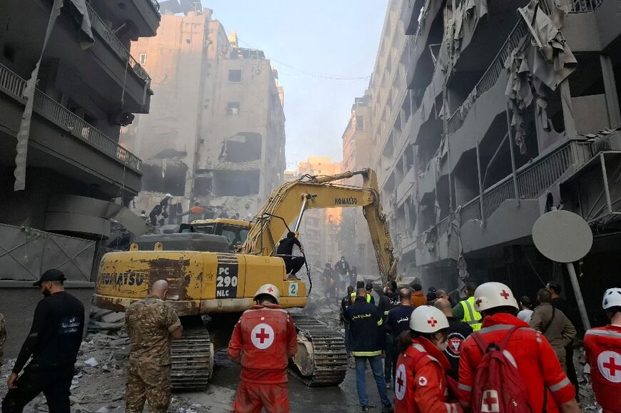 Rescuers use an excavator to clear the rubble following an Israeli air strike in Beirut's Basta neighbourhood Saturday