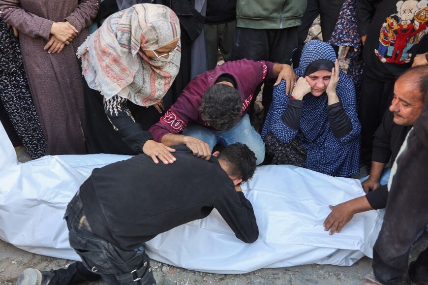 Palestinians mourn a victim of a strike on a house in Gaza City, as fighting shows no signs of abating