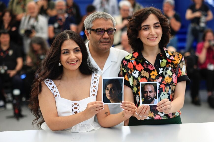 Iranian actresses Setareh Maleki and Mahsa Rostami, and director Mohammad Rasoulof, held portraits of their missing cast members at the Cannes film festival